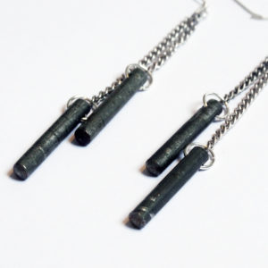 Factory Floor Jewels Steel Rods earrings close up on a white background