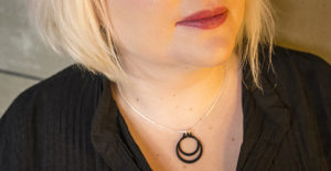 Black and silver circlips penant by factory floor jewels on model