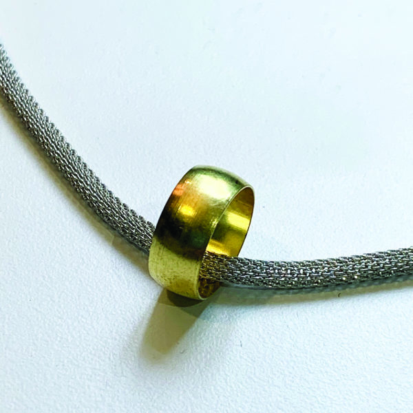 close up of steel and brass pendant