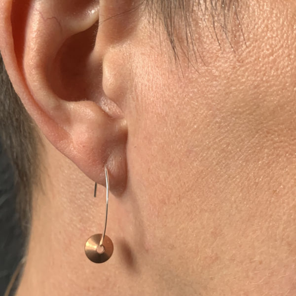 sterling silver and copper earrings shown worn to give a sense of scale