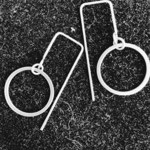 steel circle earrings on black background