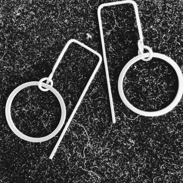 steel circle earrings on black background