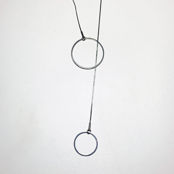 Steel lariat pendant with 2 circles shown on a white background