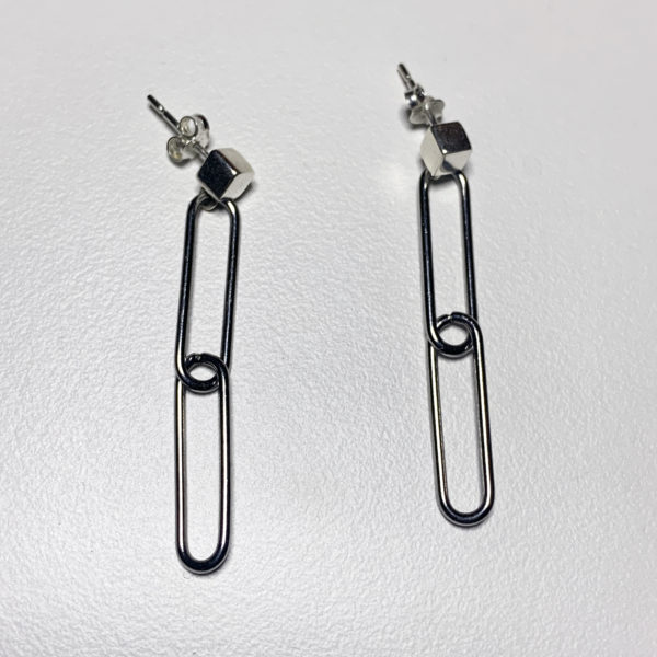 steel paperclip earrings with 2 links and a sterling silver cube stud on a white background