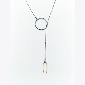 A stainless steel lariat necklace featuring a brass lozenge shape at the end. It is shown on a white background and designed and made by Factory Floor Jewels in Liverpool