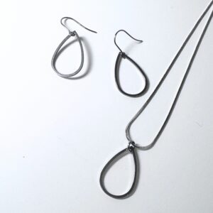 Stainless Steel Teardrop pendant and earrings by Factory Floor Jewels on a white background