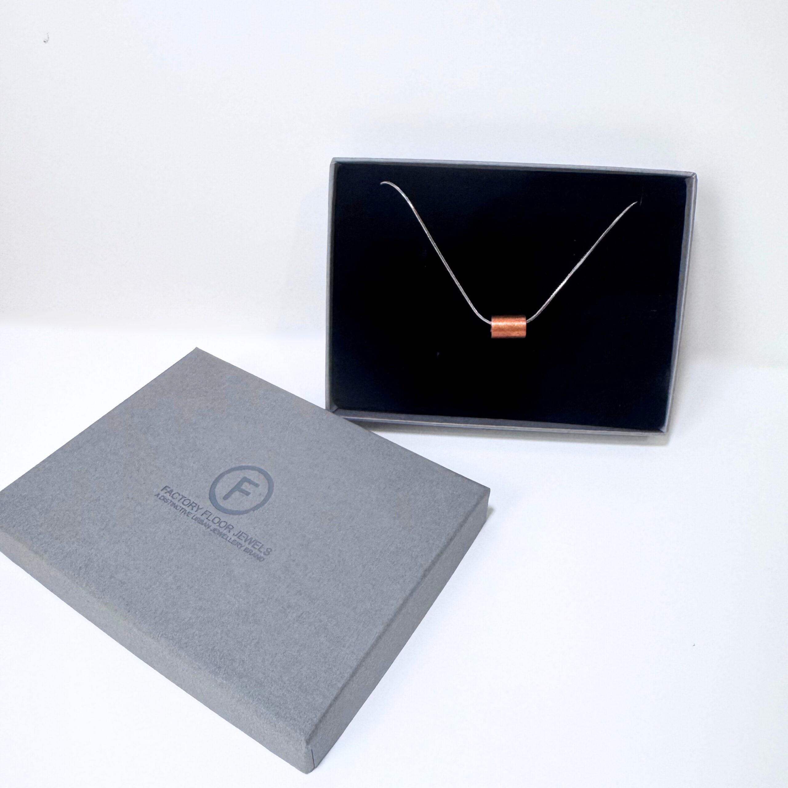Copper and steel 'weights' pendant in branded Factory Floor Jewels box
