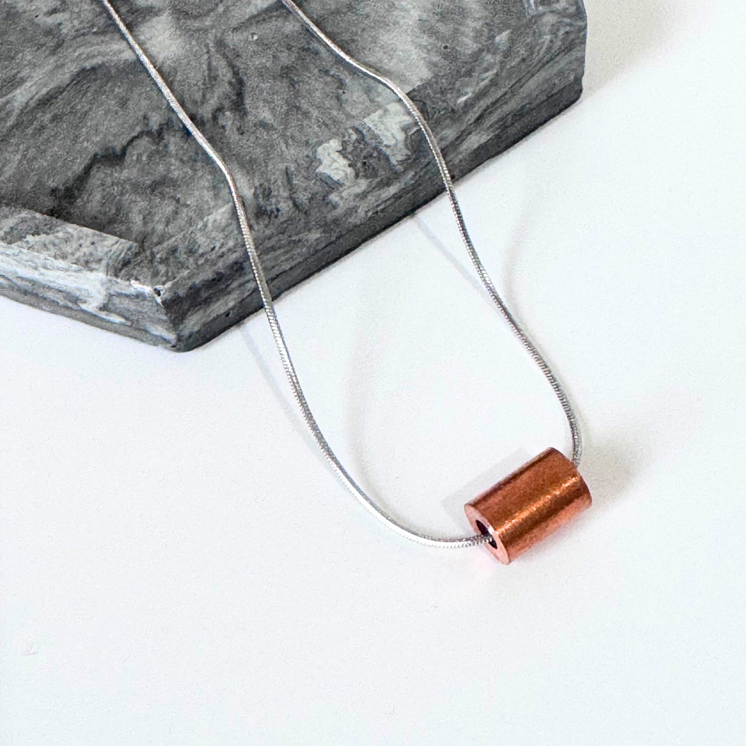 Copper 'weight' pendant on stainless steel snake chain